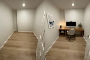 Modern commercial space featuring a minimalist office setup with a desk, chair, and decor.